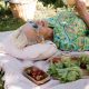 Woman over 40 enjoying a peaceful garden picnic, embracing self-acceptance, life balance, and letting go of stress.